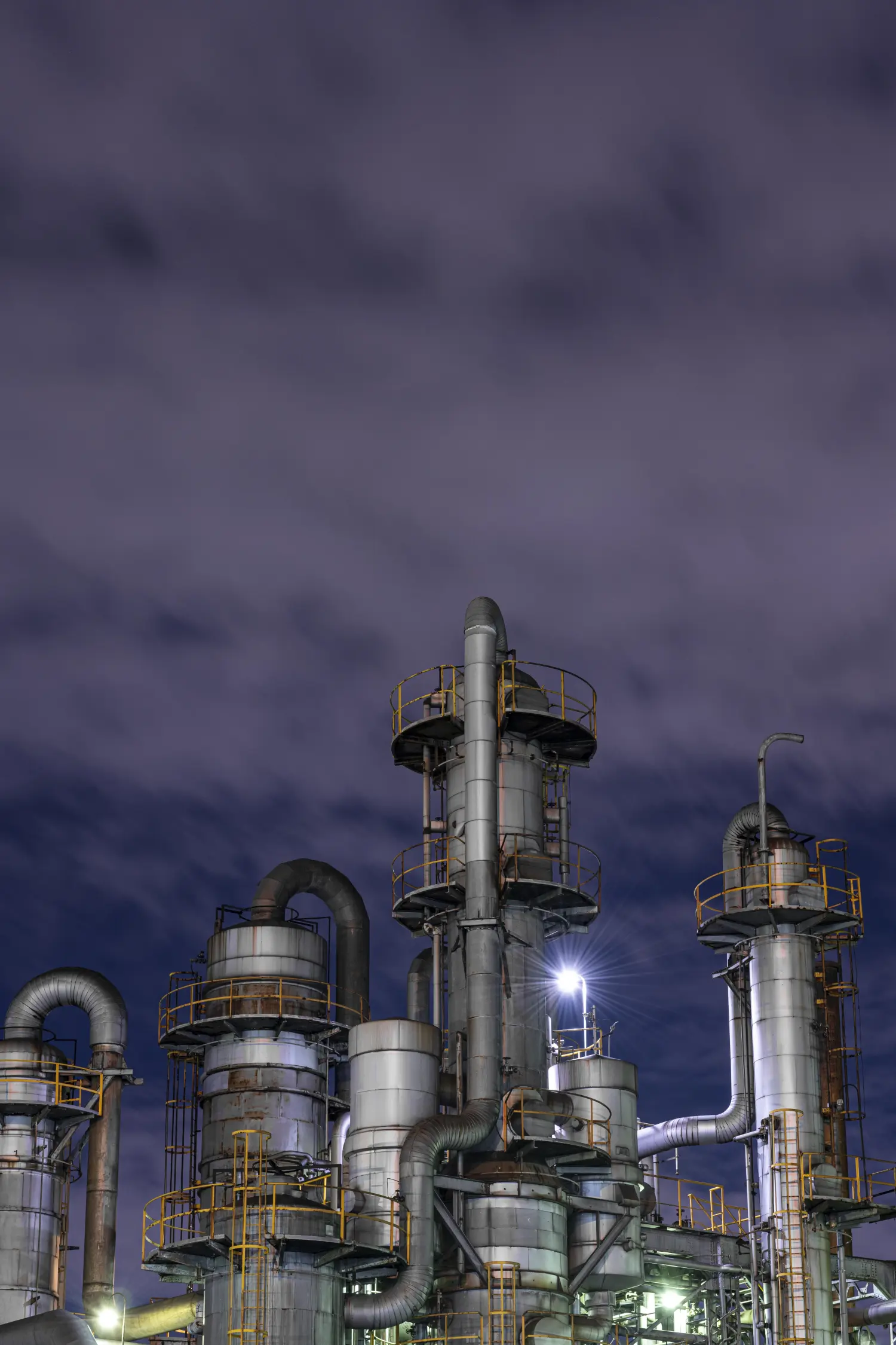 a large industrial plant with a cloudy sky